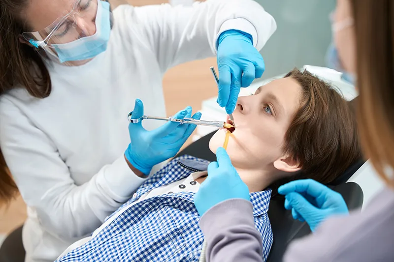 Child sitting in a dental chair for a checkup